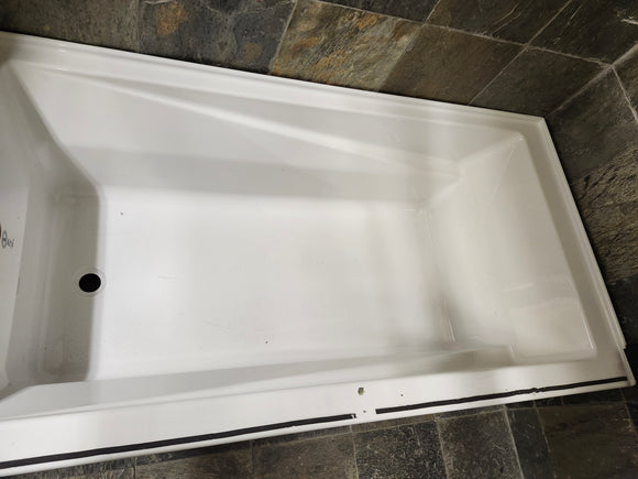 Neptune 60 x 32 built in bathtub as is floormodel with skirt afr azea k8